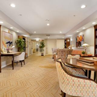 A spacious and elegantly decorated living room with comfortable seating and tasteful artwork.