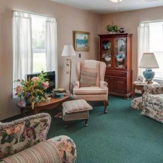 A cozy living room with classic furniture and floral decor.