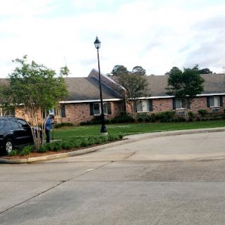 A peaceful suburban street showcasing a well-kept residential home with a landscaped yard.