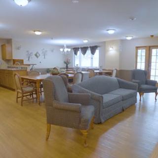 A cozy living room featuring comfortable seating and a dining area.