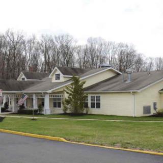 A suburban residential building with a landscaped exterior.