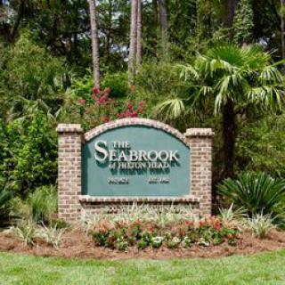 Entrance sign for The Seabrook of Hilton Head surrounded by lush greenery.