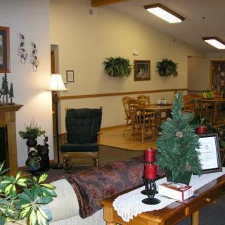 A cozy interior with comfortable seating, decorative plants, and warm lighting.