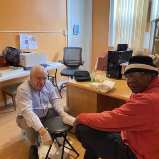 Two individuals in an office setting engaged in a conversation.