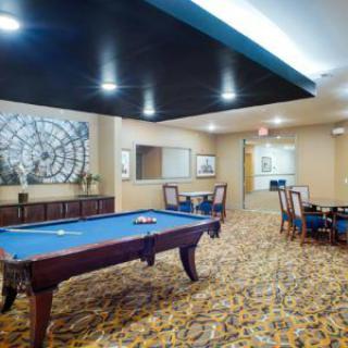 A modern indoor game room featuring a pool table and stylish decor.