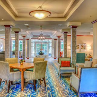 A cozy and well-lit hotel lobby with comfortable seating and elegant decor.