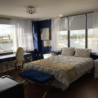 A modern bedroom with natural light and a scenic window view.