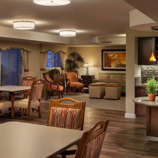 A cozy living and dining area with warm lighting, comfortable furniture, and tasteful decor.