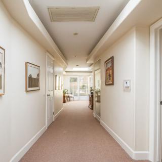 A bright and inviting hallway with artwork adorning the walls.