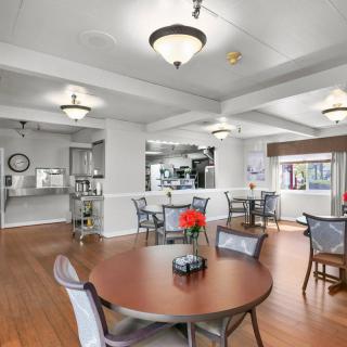 A modern dining area with round tables, chairs, and ambient lighting.