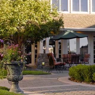 A serene garden patio with outdoor seating and lush greenery.