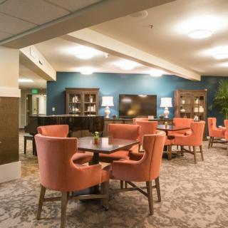A cozy and elegant dining area with plush chairs and warm lighting.