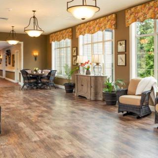 Spacious living room with wood flooring and natural light.