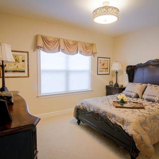 A cozy and traditionally styled bedroom with elegant furniture and decor.