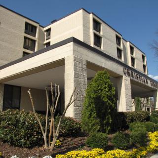 Exterior view of a hotel surrounded by greenery.