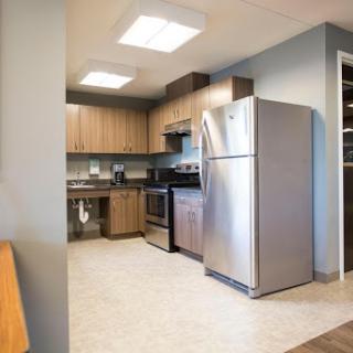 A modern kitchen featuring stainless steel appliances and wooden cabinetry.