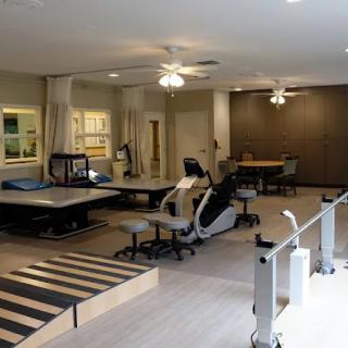 A rehabilitation room equipped with therapy and exercise equipment.