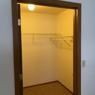 An empty closet with shelving ready for organization.