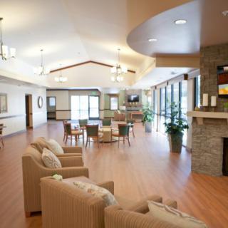 Spacious and well-lit living room with comfortable seating and a fireplace.