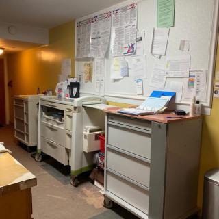 A well-organized office workspace with desks and paperwork.