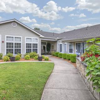 A charming residential house with a well-maintained front yard and garden.