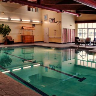 An inviting indoor swimming pool with a relaxation area.