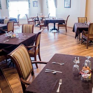 An elegant restaurant dining area with neatly set tables and chairs.