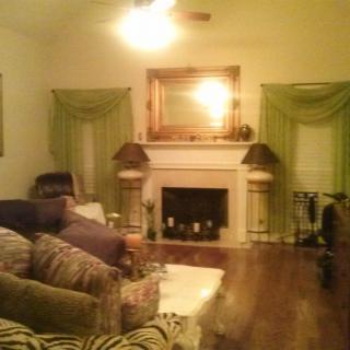 A cozy living room with a fireplace, sofa, and elegant decor.