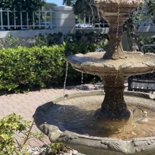 A scenic garden fountain on a sunny day.
