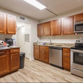 Modern kitchen with wooden cabinets and stainless steel appliances.