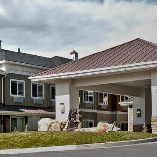 Exterior view of a modern residential building with a covered entrance.