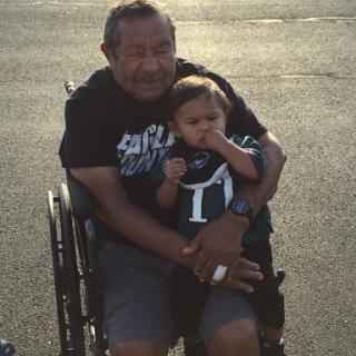 A joyful moment shared between a grandfather and his grandchild.