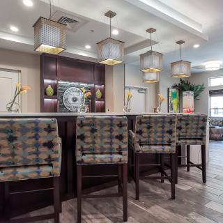 A modern bar area with stylish seating and elegant lighting.