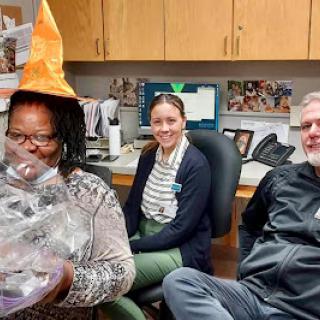 Team members enjoying a festive moment at the office.