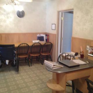 A cozy kitchen with a small dining area, featuring a table and several chairs.