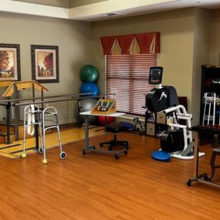 A rehabilitation room equipped with various physical therapy tools and exercise equipment.