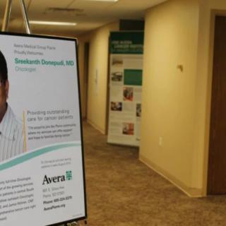 Hospital hallway with a sign featuring a doctor's profile at Avera.