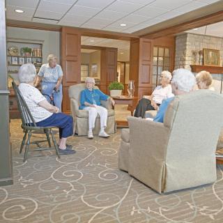 A group of elderly individuals gathered in a communal living area.