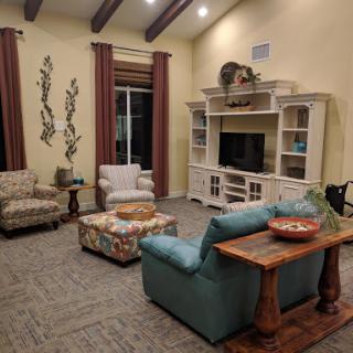 A cozy living room featuring comfortable seating and a TV setup, ideal for relaxation and gatherings.