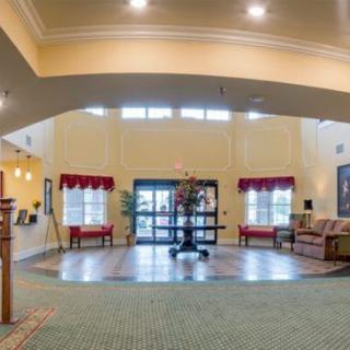 Spacious lobby interior with seating and decor.
