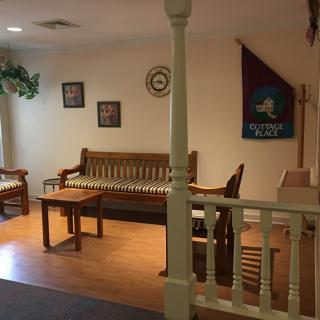 A cozy living room with wooden furniture and decorative items.