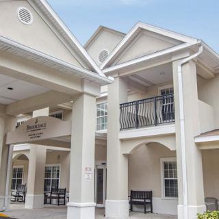 A residential building with prominent columns and a covered entrance.