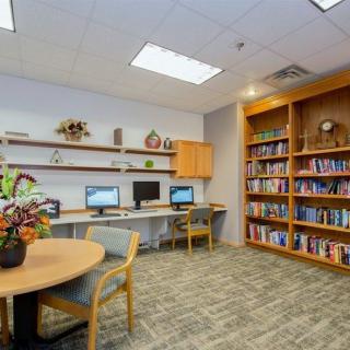 A library room with bookshelves, computers, and seating areas for study.
