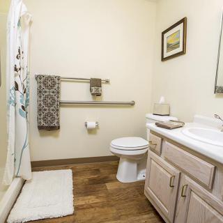 A neatly organized bathroom with essential fixtures and decor.