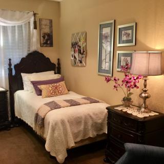 A cozy bedroom with traditional furnishings and decorative elements.