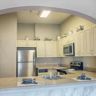 A modern kitchen with stainless steel appliances and sleek cabinetry.