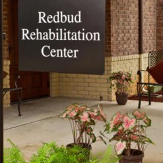 Entrance to Redbud Rehabilitation Center with decorative plants.