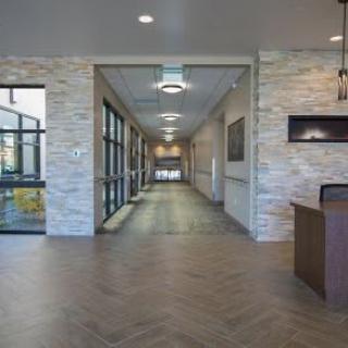 A modern, well-lit hallway with sleek flooring and contemporary design elements.