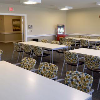 A conference room with several tables and chairs arranged for a meeting.