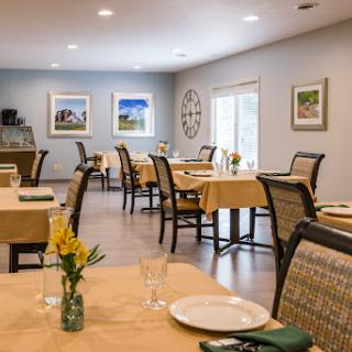 A cozy dining area with neatly arranged tables and decorative elements.